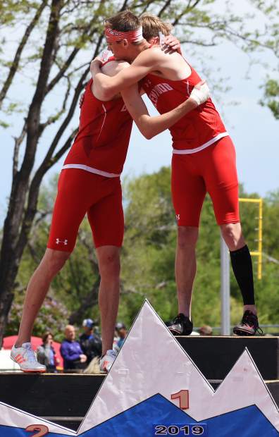 Glenwood Springs seniors Bryce Risner, left, and Wyatt Ewer hug on top of the championship podium after the 4A 300m hurdles Saturday in Lakewood. The senior duo finished 1-2.