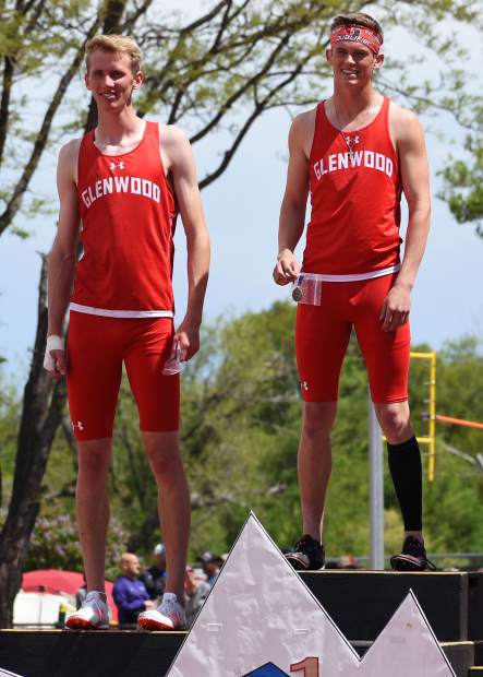 Glenwood Springs senior Wyatt Ewer holds his championship medal for the 4A 300m hurdles, while teammate Bryce Risner stands next to him in second place.