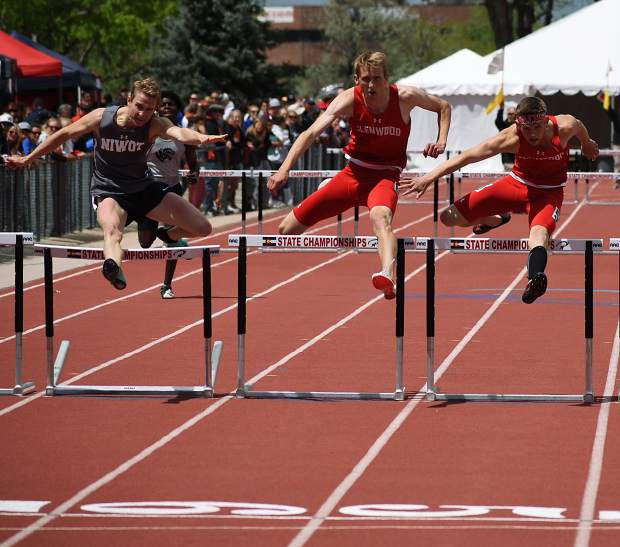 Seniors Bryce Risner (center) and Wyatt Ewer (right) leap over the final hurdle Saturday in the 4A 300m hurdles, while Niwot's Jensen Doulliard, left, closes in. Ewer edged Risner by 4/100ths of a second to win the 4A state championship.