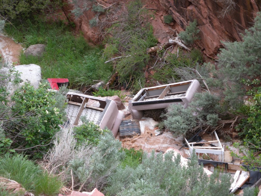 Trash piles up in Red Canyon Creek as a result of illegal dumping over the years.