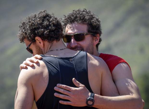 Nancy Reinisch’s sons Marco and Chas Salmen share an embrace after finishing heat 1 of the Mother’s Day Mile Sunday in Glenwood Springs.