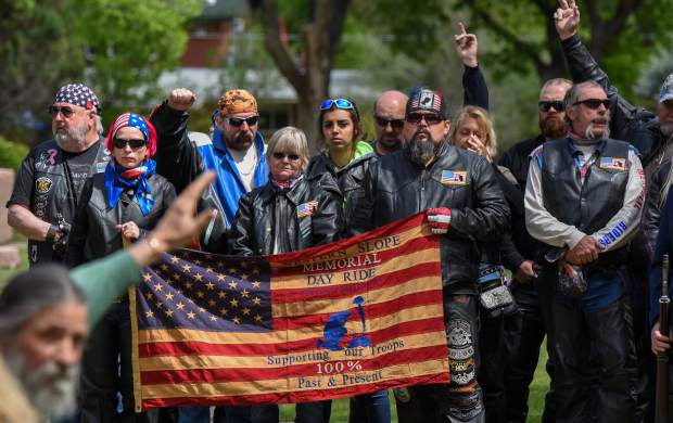 Veteran members of the audience are asked to raise their hands to be recognized during the opening of the 2019 Memorial Day ceremony held at Rosebud Cemetery in Glenwood Springs on Monday.