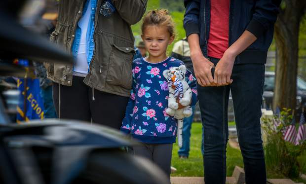 A young girl watches as the Western Slope Memorial Riders leave Rosebud Cemetery during the closing of the 2019 Memorial Day ceremony on Monday morning.