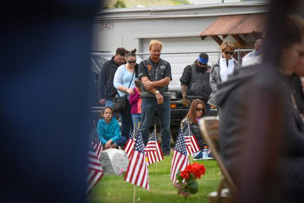 A member of the audience lowers his head during the benediction near the closing of the 2019 Memorial Day ceremony held at Rosebud Cemetery in Glenwood Springs on Monday.