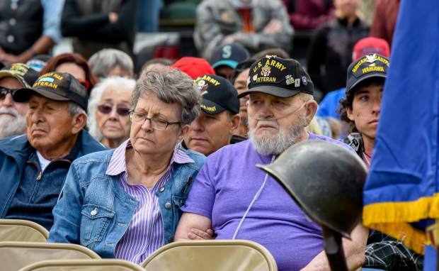 Members of the audience sit together and listen to the rendition of Amazing Grace by Catherine Zimney during the 2019 Memorial Day ceremony held at Rosebud Cemetery in Glenwood Springs on Monday.